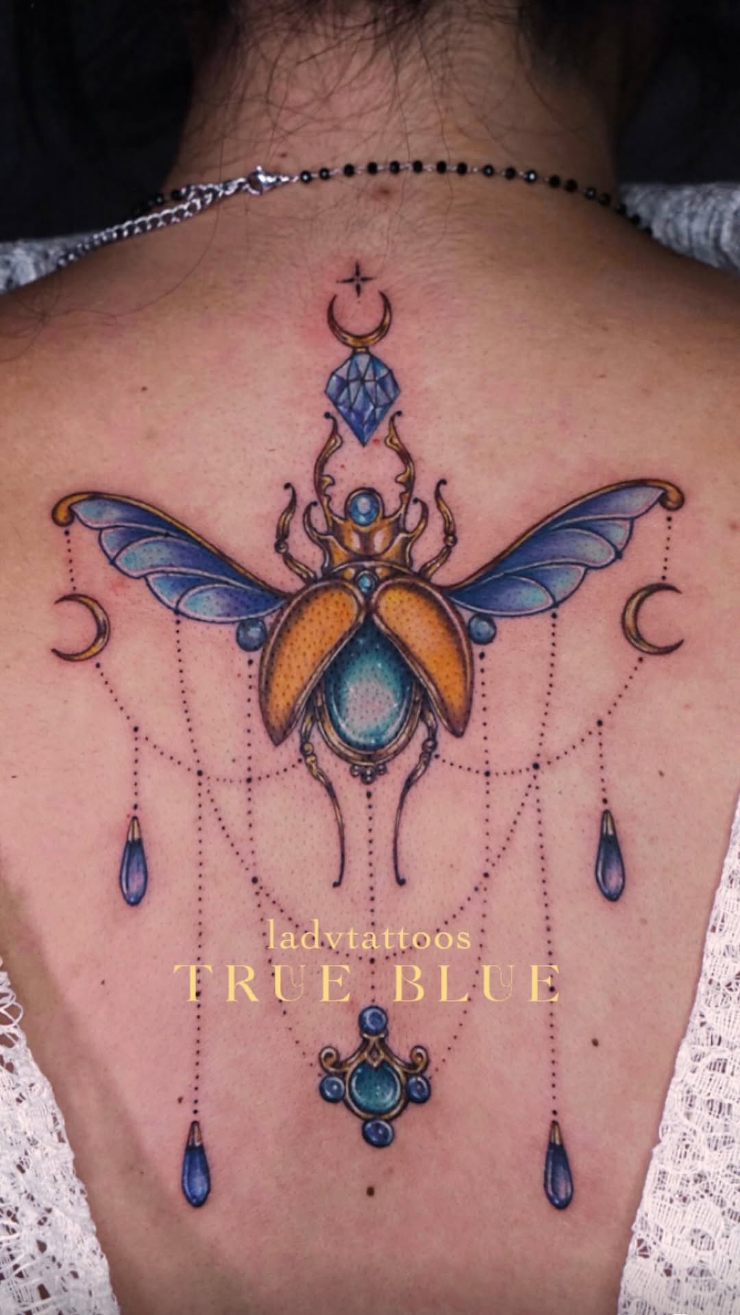 Vibrant jeweled insect centerpiece with crystal droplets