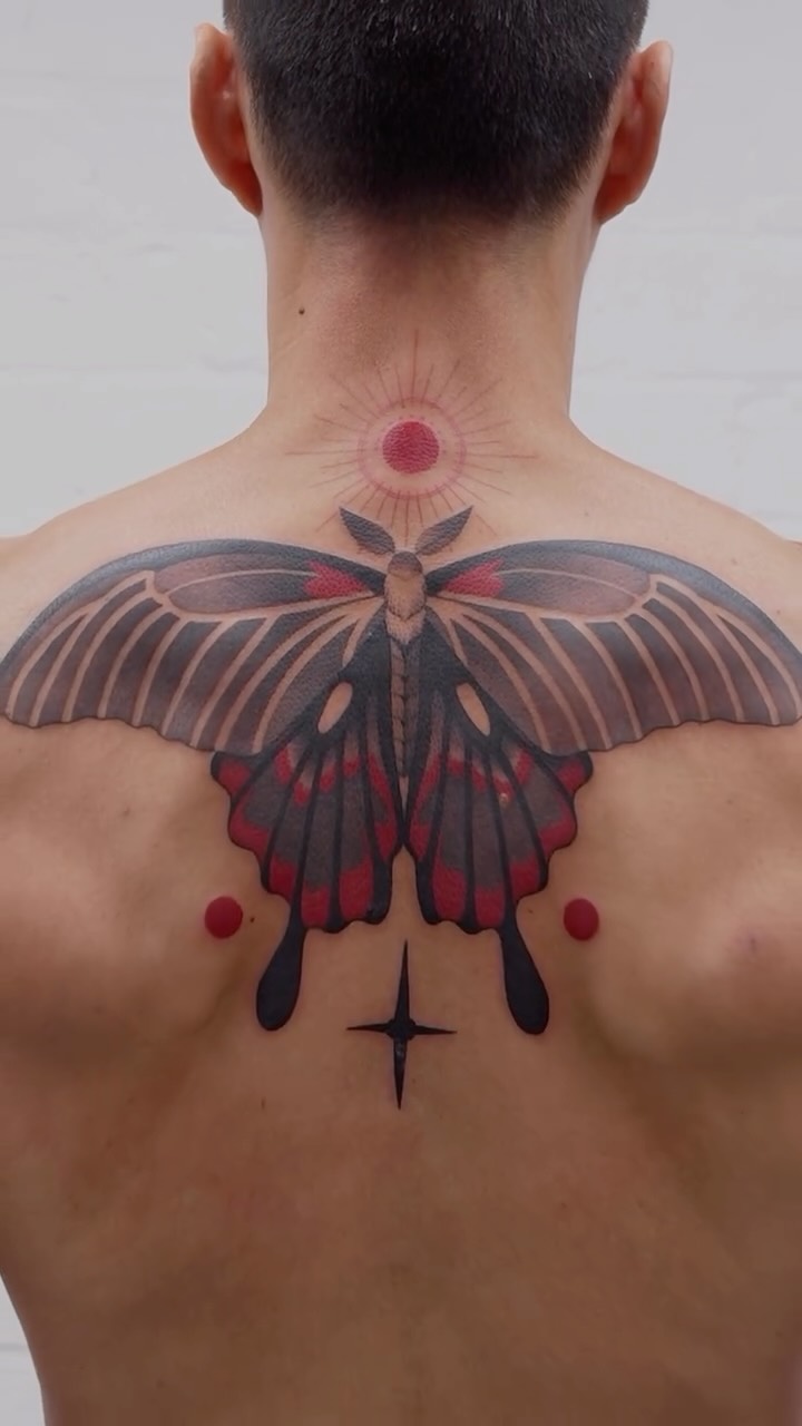 Symmetrical black-and-red moth back piece with sunburst