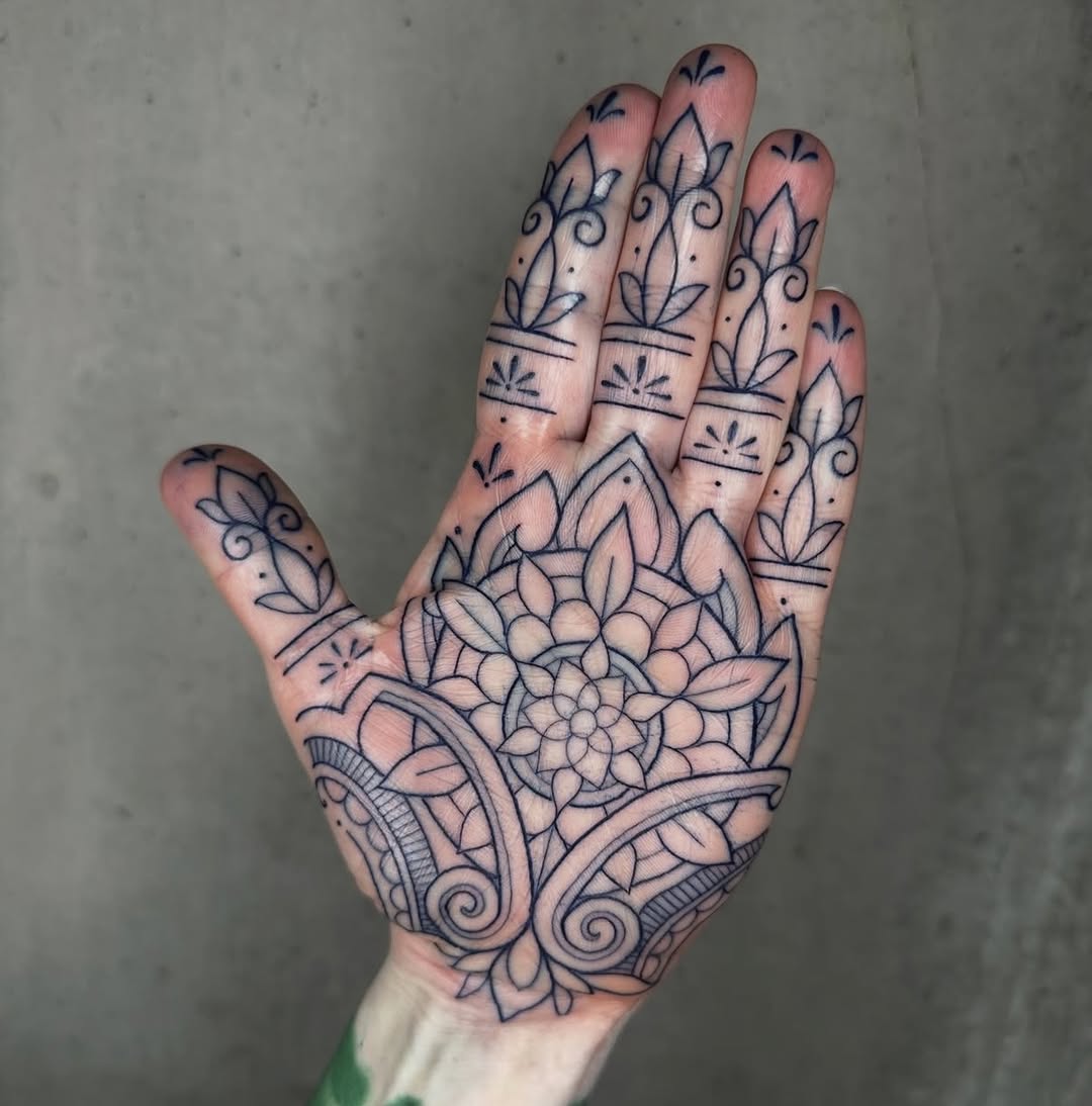 Intricate palm-finger floral mandala in bold blackwork