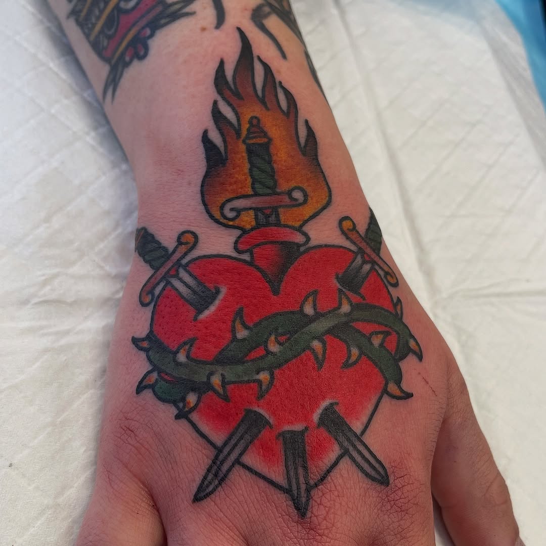 Bold heart with barbed wire, dagger, and flame