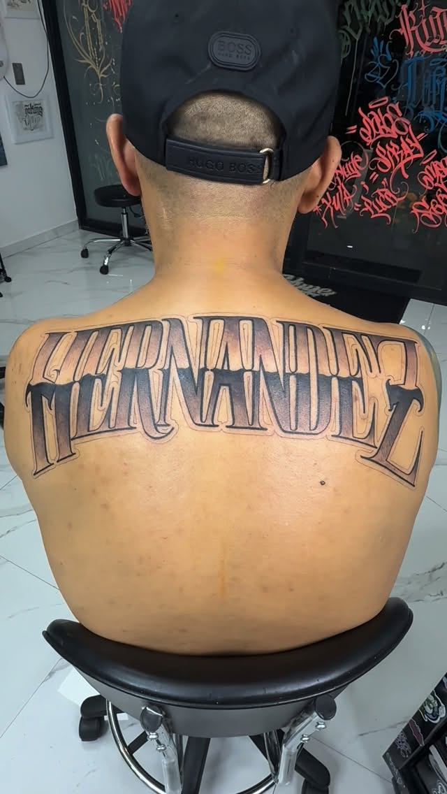Bold, ornate back script spelling FERNANDEZ across shoulders.