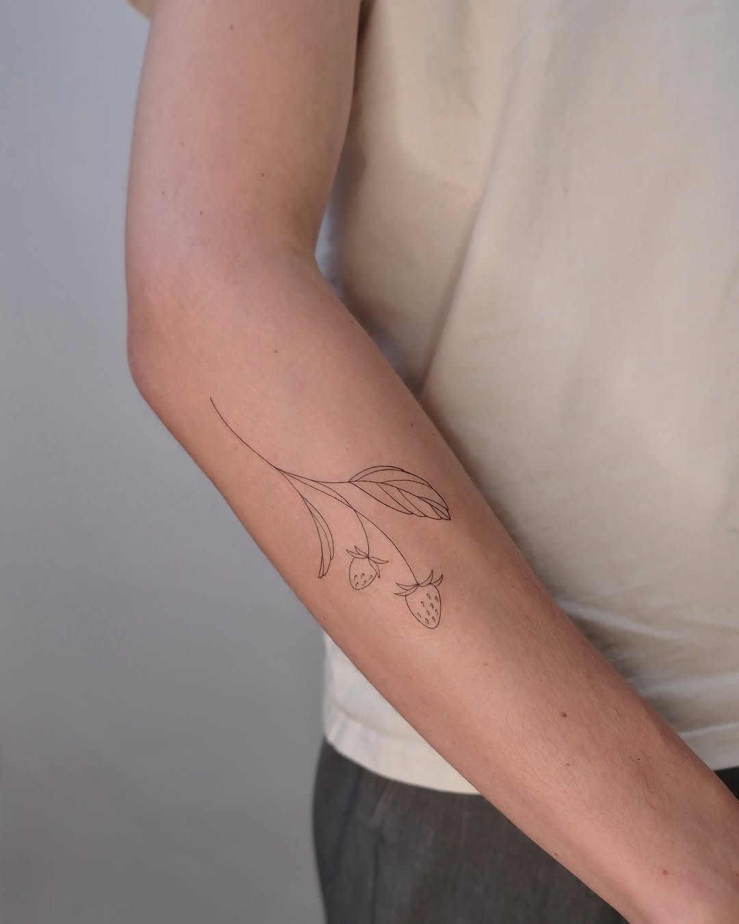 Delicate minimalist berry branch with strawberries