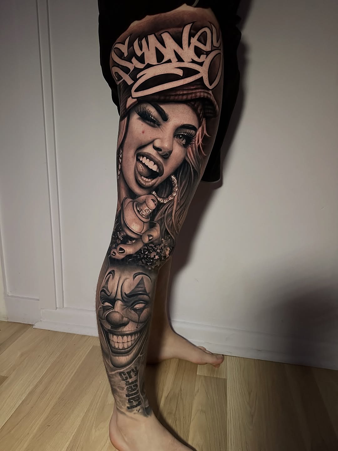 Striking black-and-gray leg sleeve with hyper-real portraits