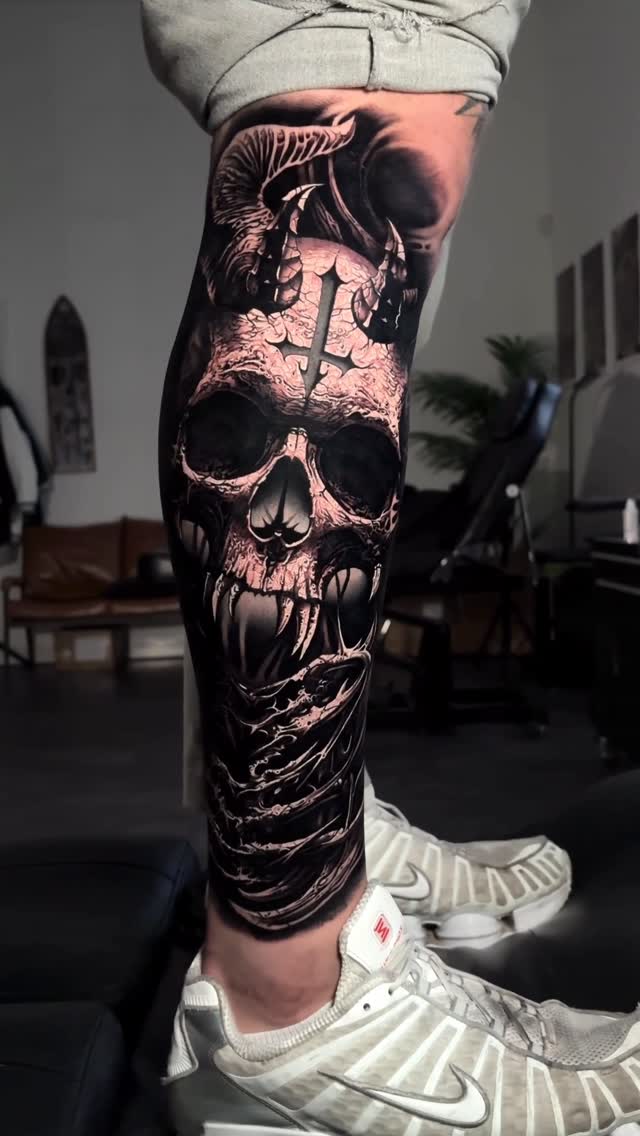 Gothic blackwork demon skull with jagged fangs and shadows