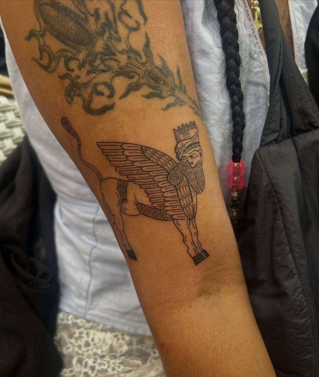 Lamassu-inspired winged-humanoid guardian with bold linework