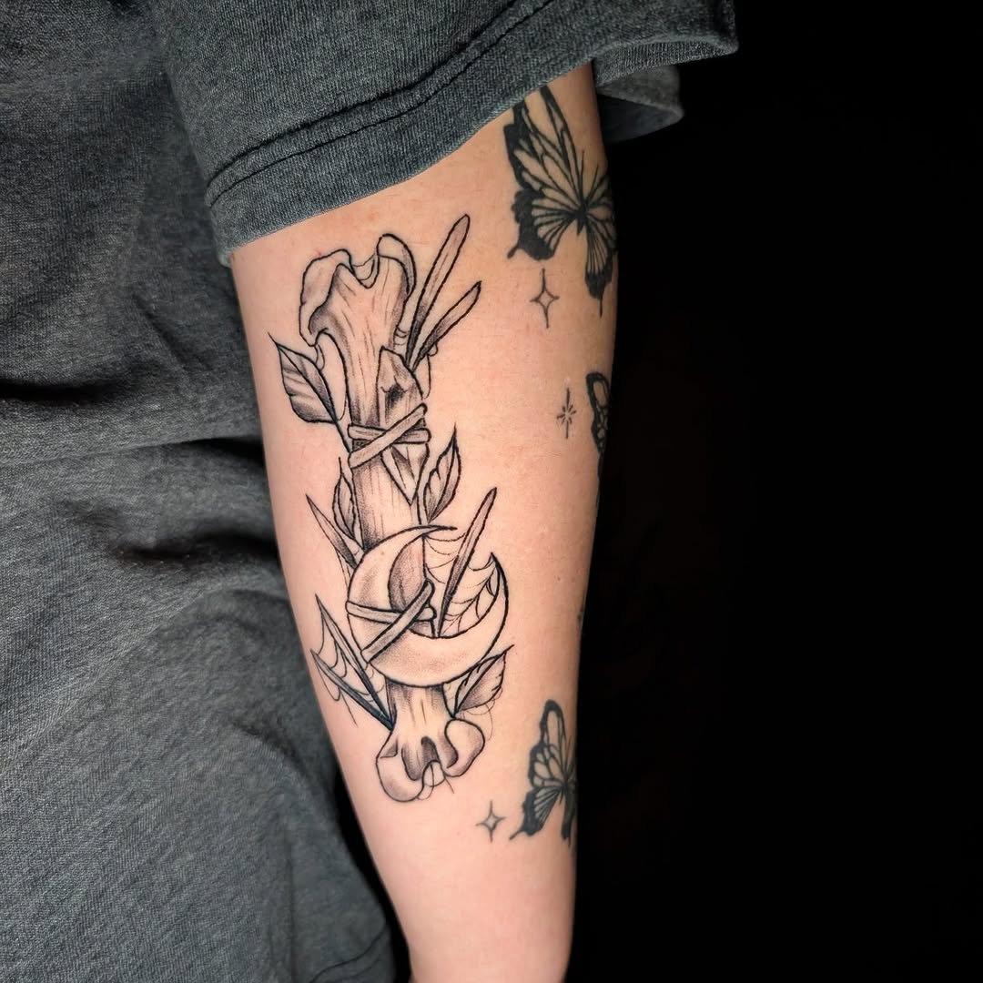 Gothic bone wrapped by curling vines and crescent moon