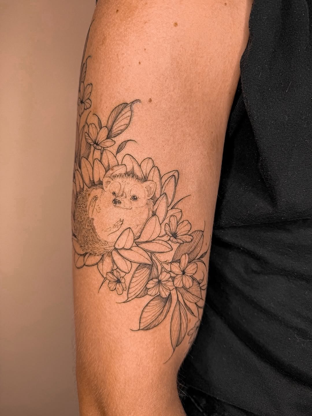 Delicate line-work hedgehog amid blooming florals