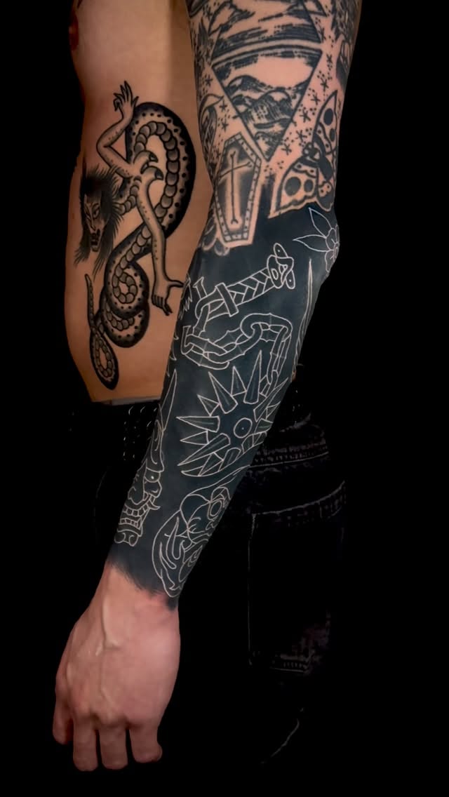 White-line illustrative sleeve over black shading, serpentine motif