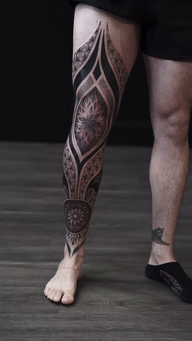 Intricate full-leg geometric blackwork with mandala panels