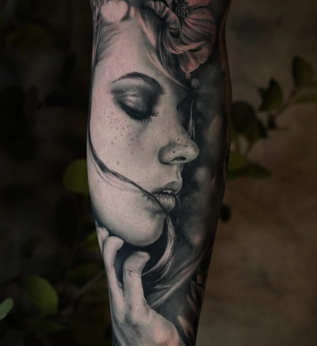 Hyper-realistic black-and-gray portrait of a serene woman