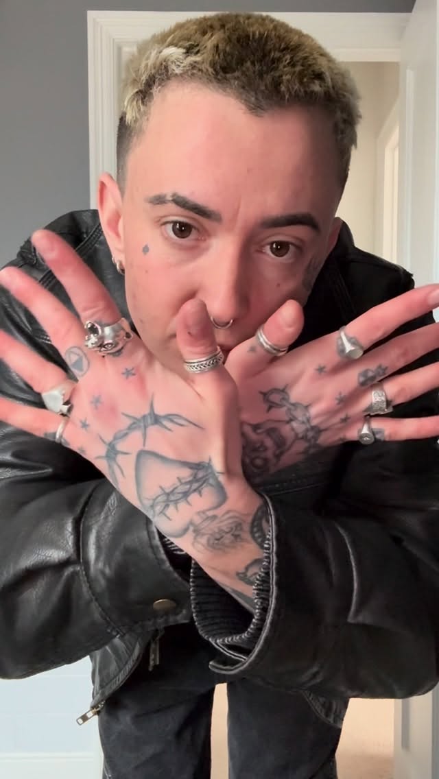 Bold blackwork hand and forearm tattoos with star accents