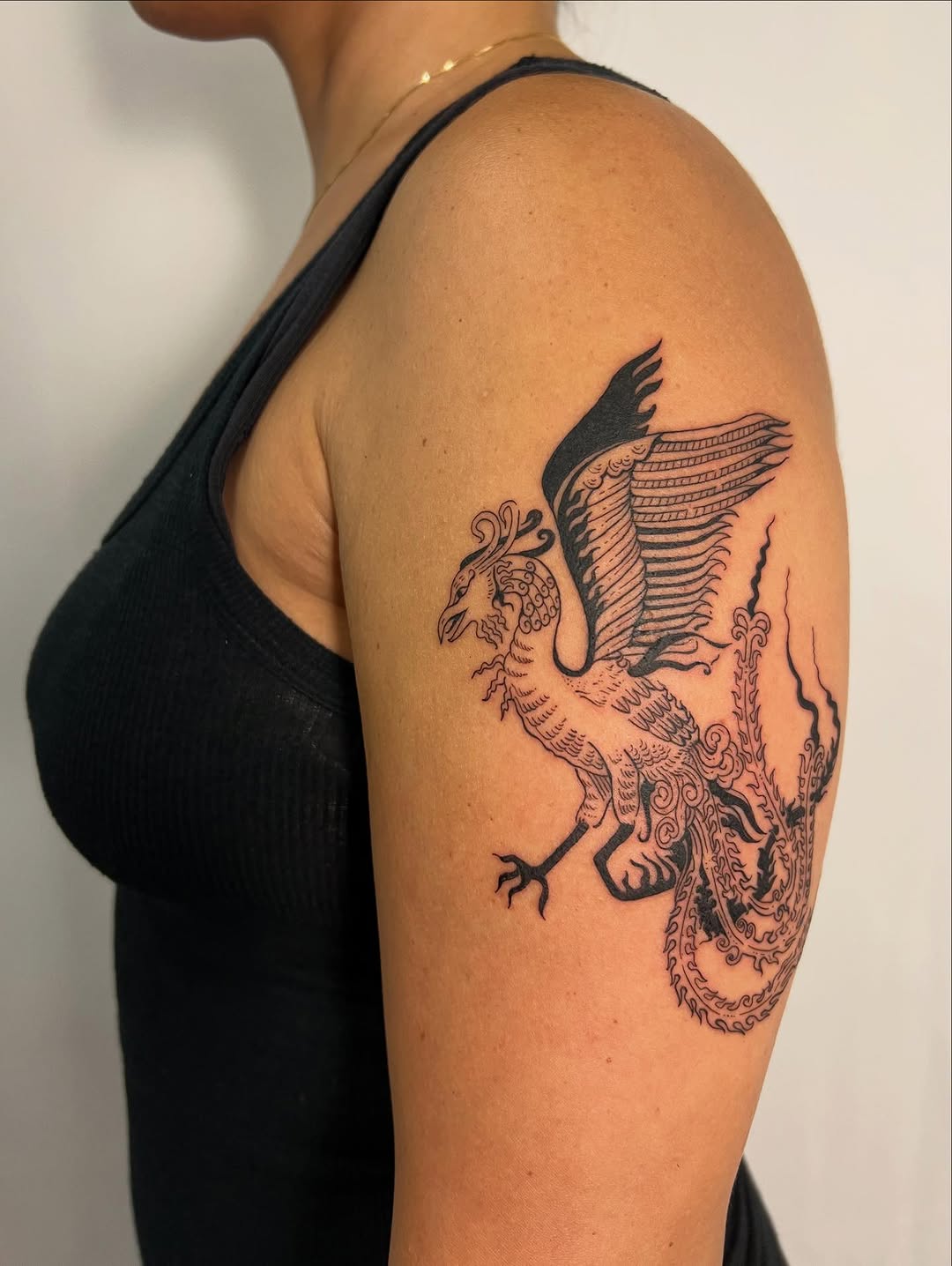 Mythical Simurgh-inspired phoenix with ornate, swirling plumage.