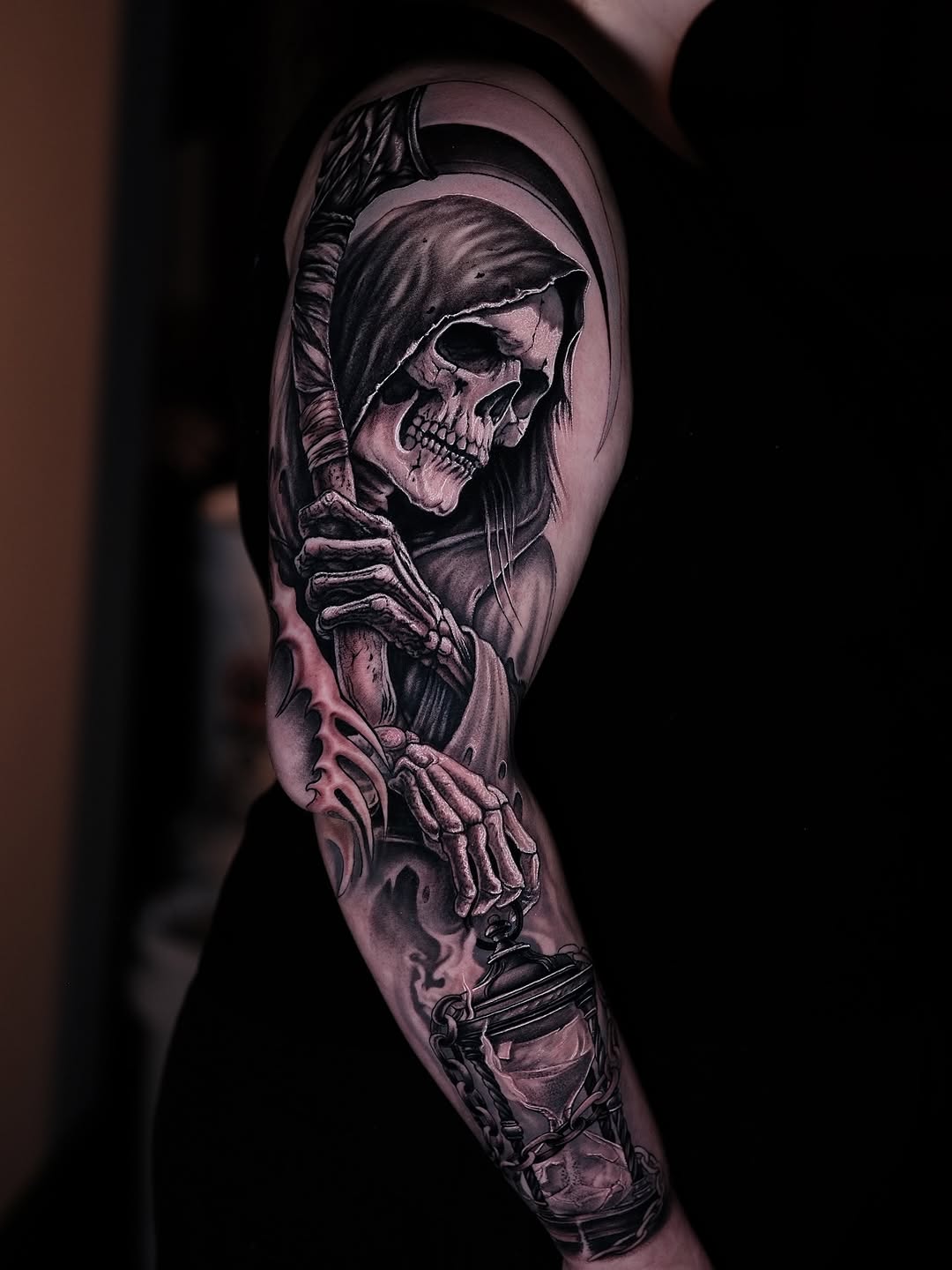 Hyper-detailed black-and-gray Grim Reaper skeleton sleeve.