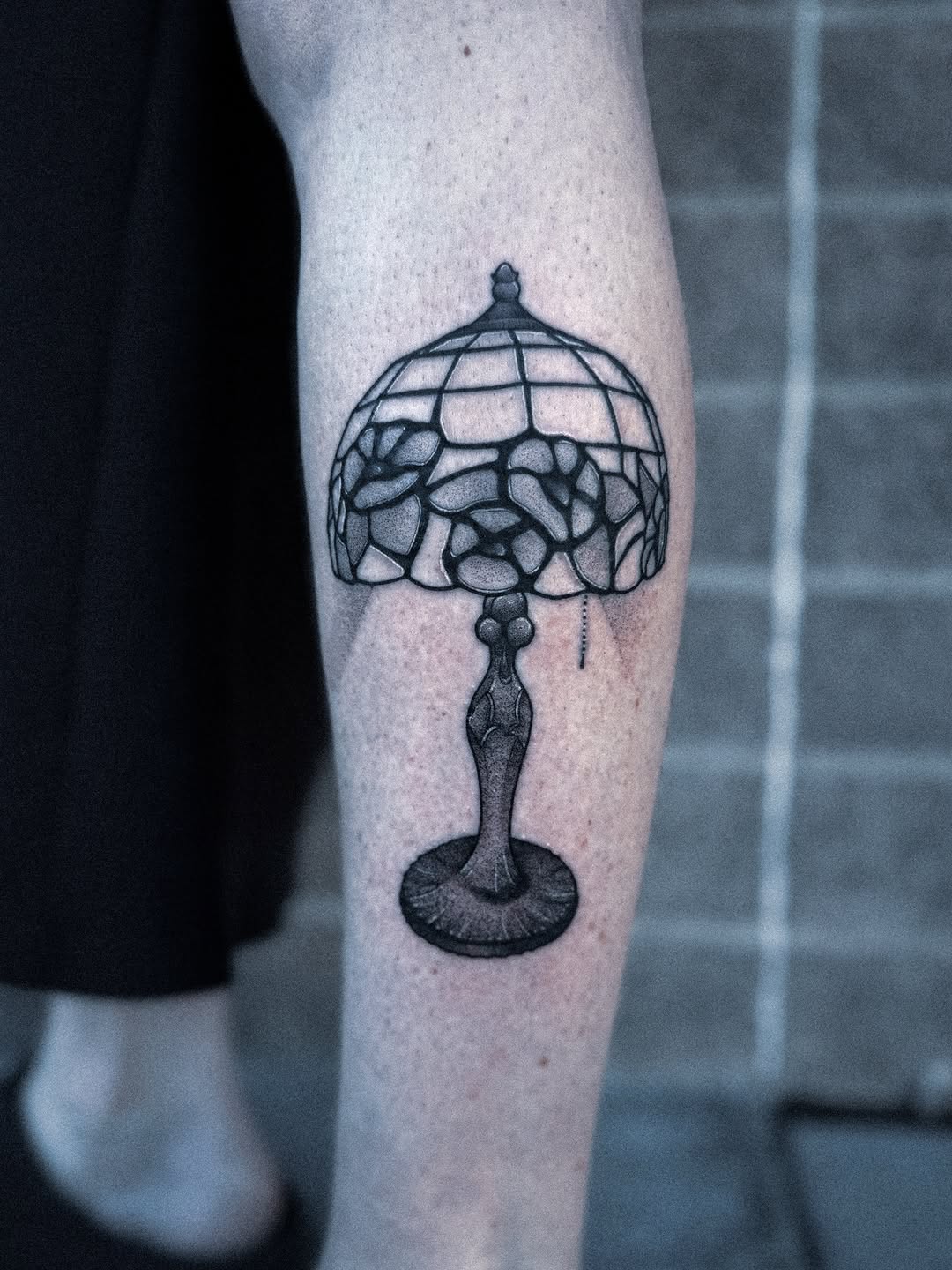 Tiffany-style lamp tattoo with stained-glass mosaic segments
