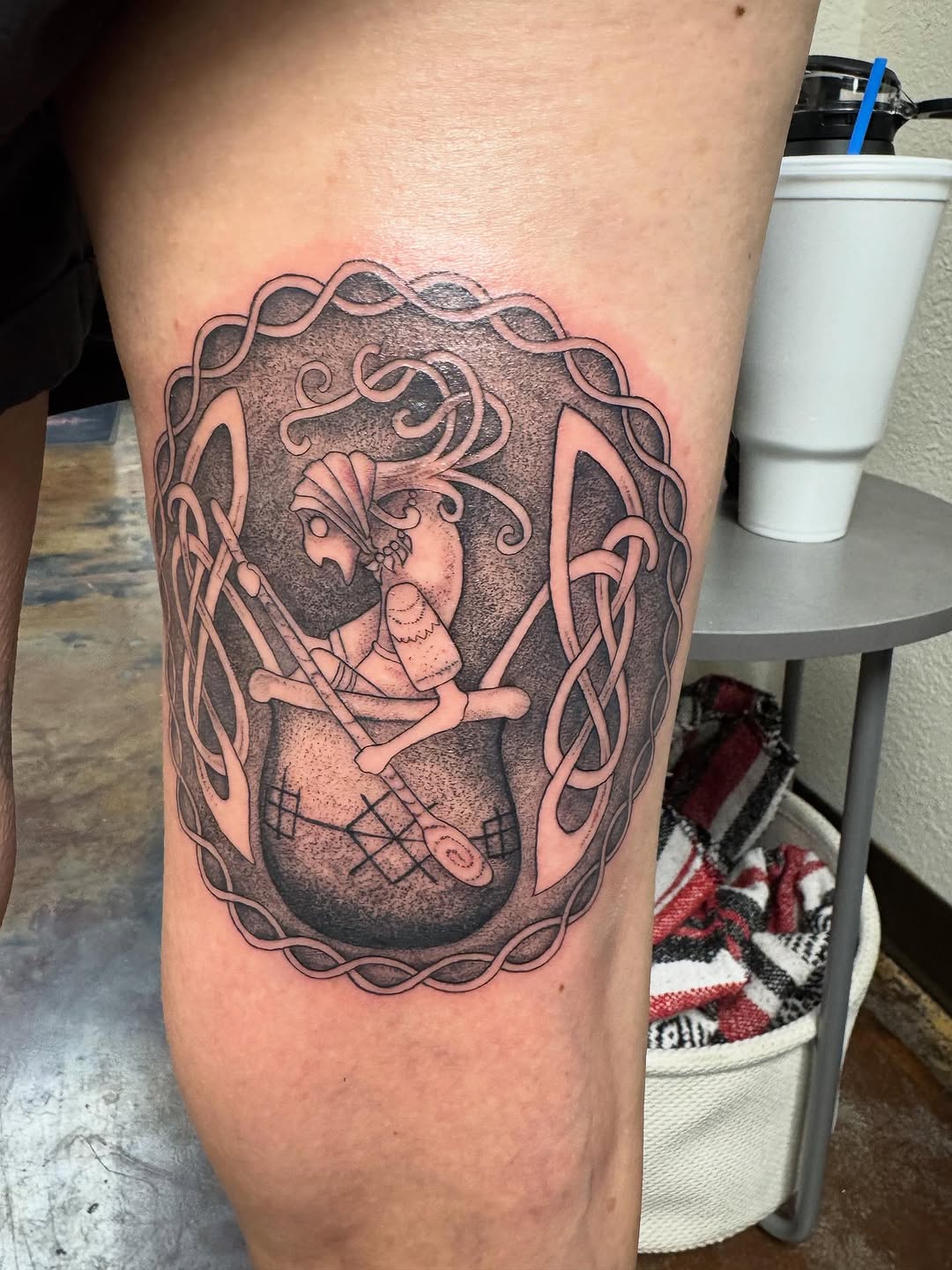 Intricate blackwork heart frame enclosing a skeletal knotwork scene