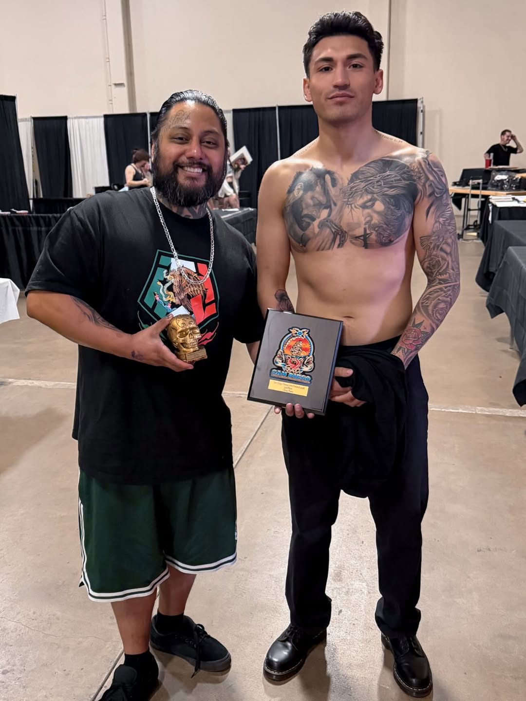 Large black-and-grey chest piece featuring twin portraits with dramatic shading