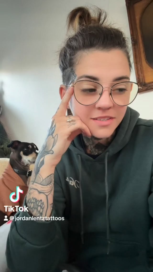 Bold black floral forearm piece with sweeping shading