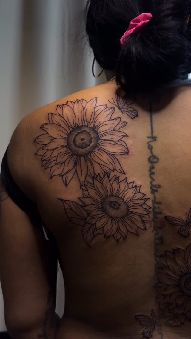 Bold botanical back piece of sunflowers with script