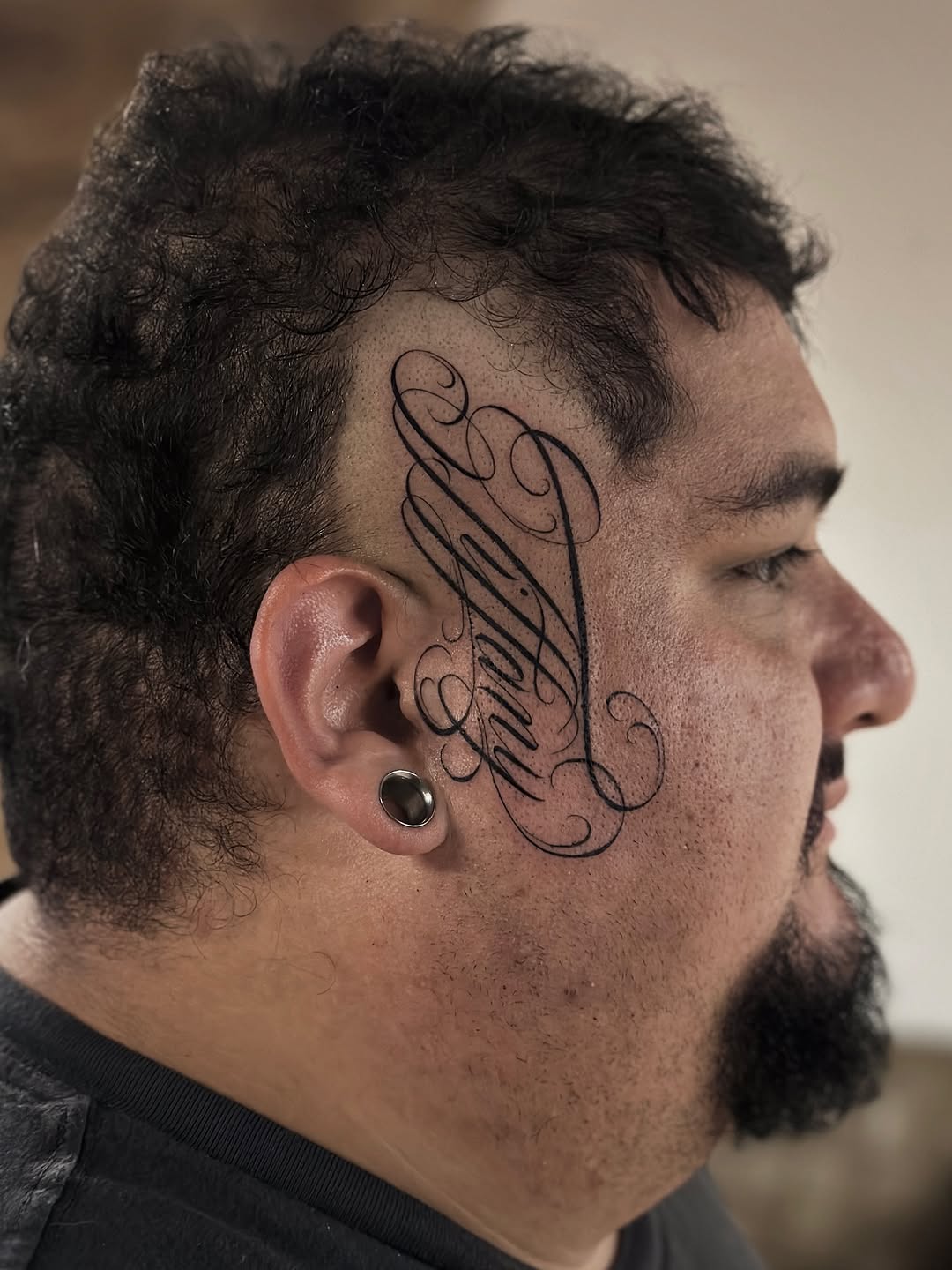 Elaborate ornamental script wraps around the temple.