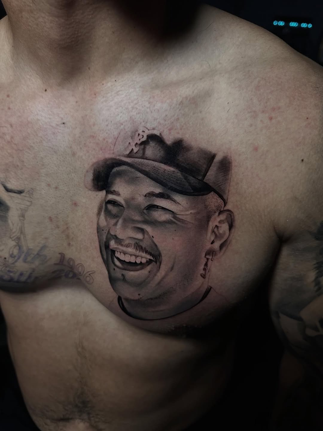 Hyper-realistic grayscale portrait of a smiling man in a cap