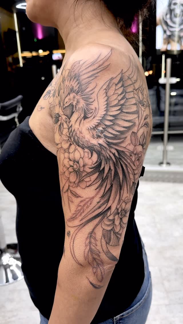 Delicate black-and-gray phoenix with blooming florals