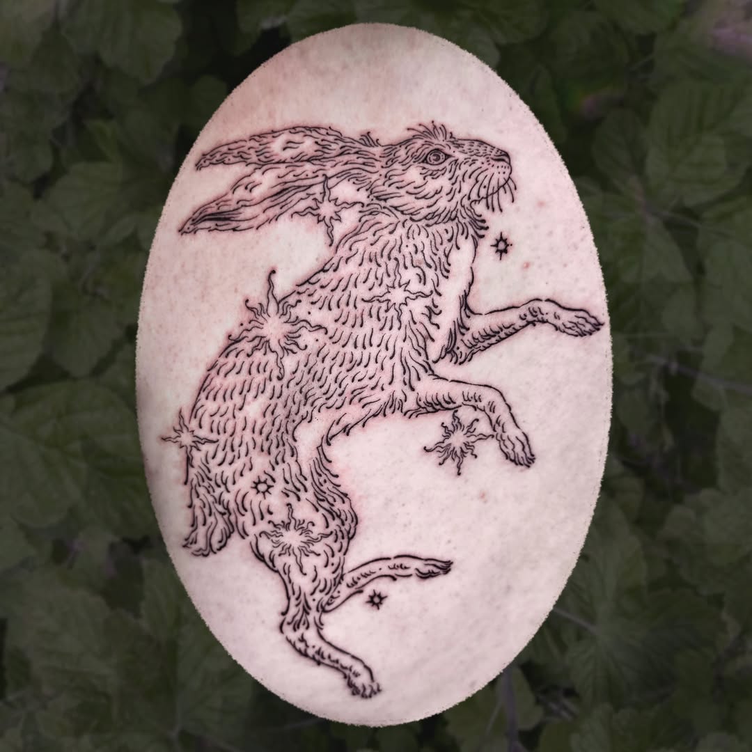 Delicate leaping hare in fine-line blackwork, celestial stars.