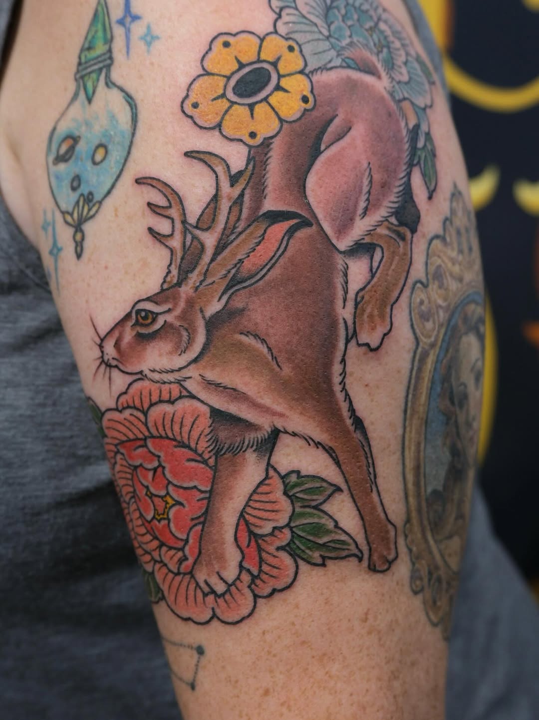 Vibrant neo-traditional jackalope perched above a lush peony