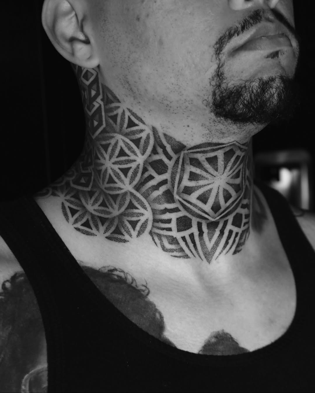 Intricate geometric neck tattoo with tessellated circular motifs