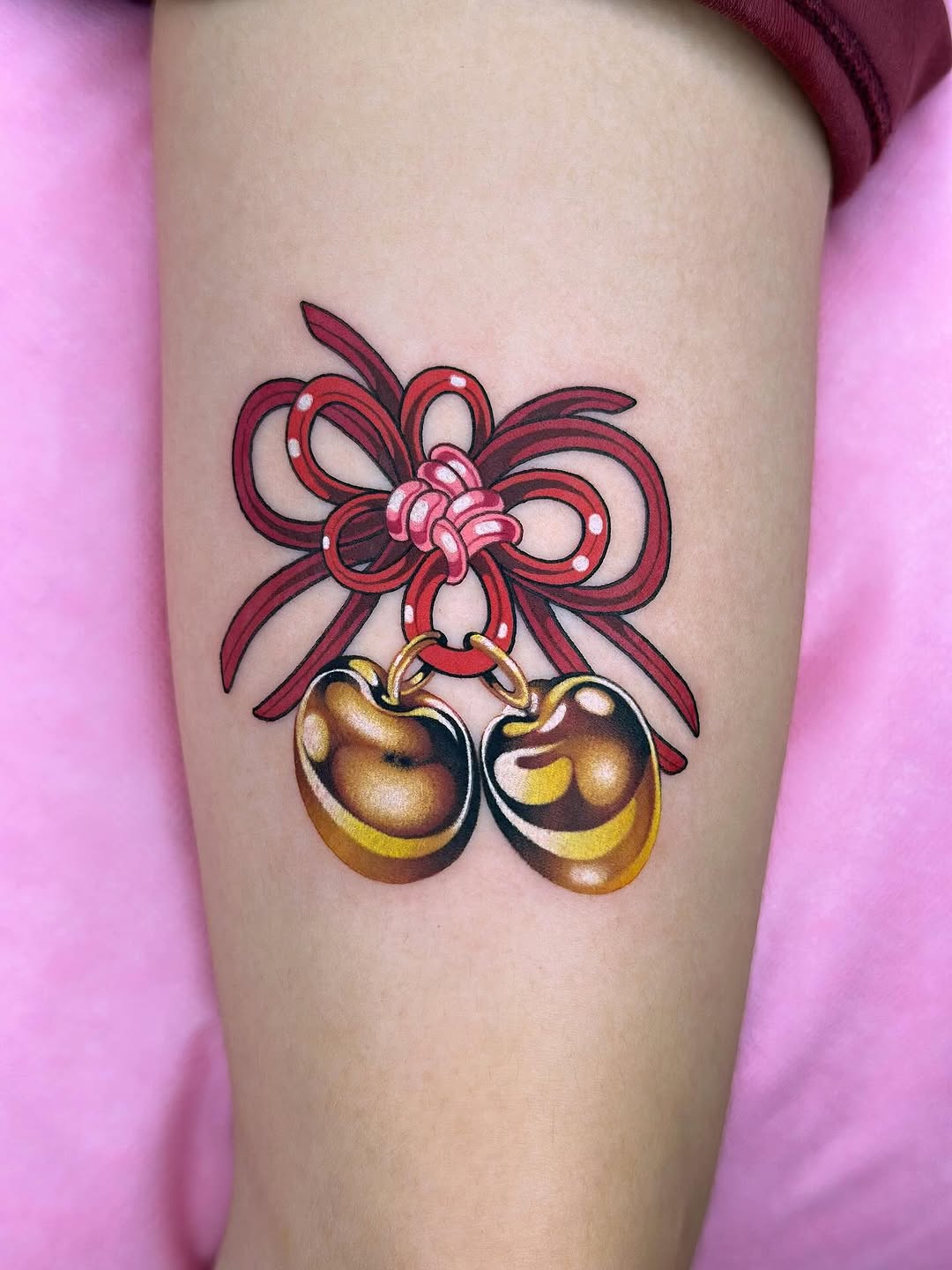 Bold red bow with shining gold bells, traditional flair.