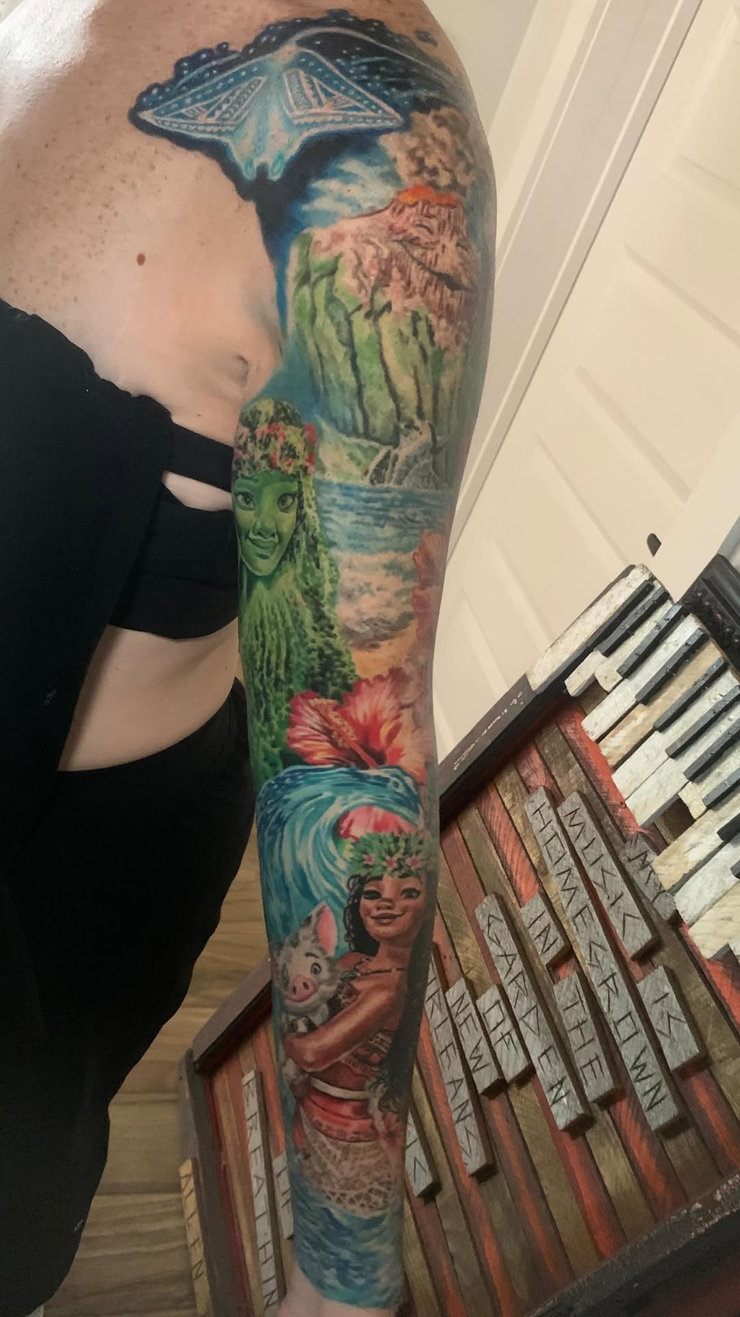 Vibrant Polynesian-floral sleeve with island scenery and characters.