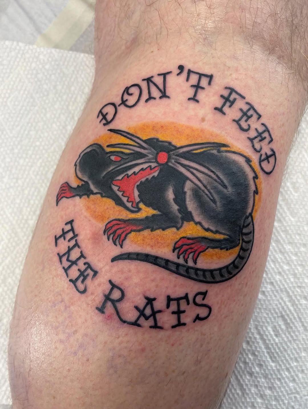 Bold neo-traditional rat with orange halo and curved text