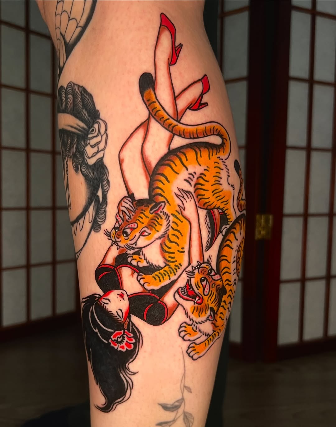 Vibrant Japanese-style tattoo of a girl with two tiger cubs