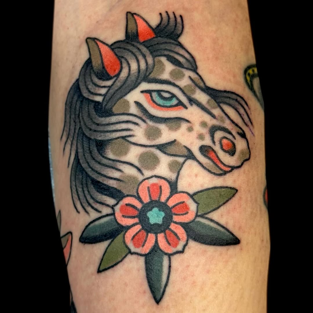 Bold traditional horse head with a pink flower