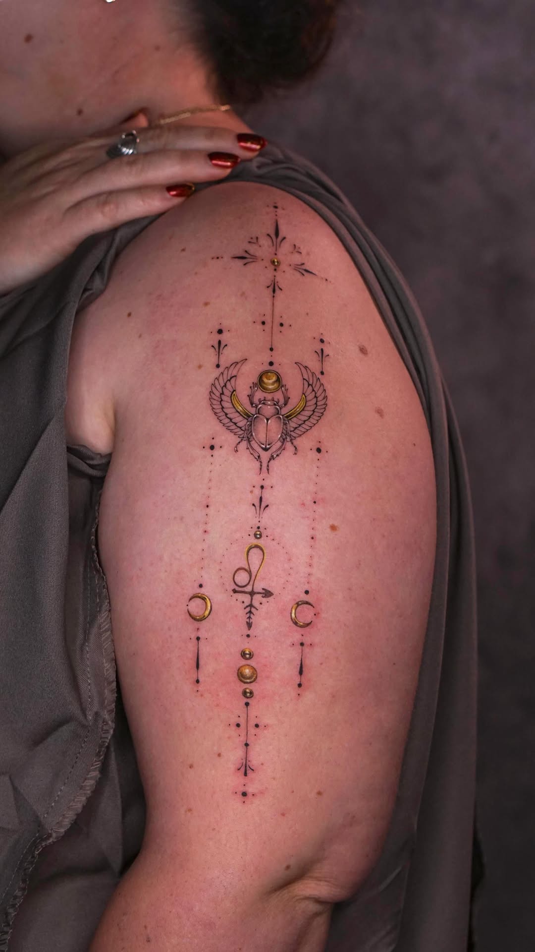 Egyptian-inspired linework with winged scarab and celestial dots