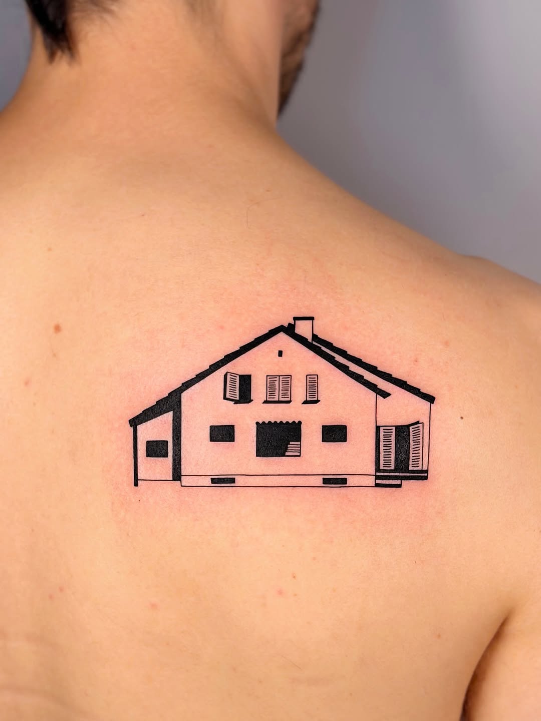 Bold minimalist house silhouette with geometric windows.