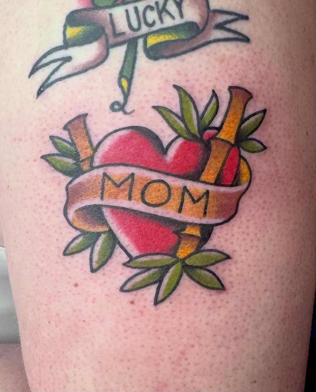 Bold traditional heart with MOM ribbon, bright colors.
