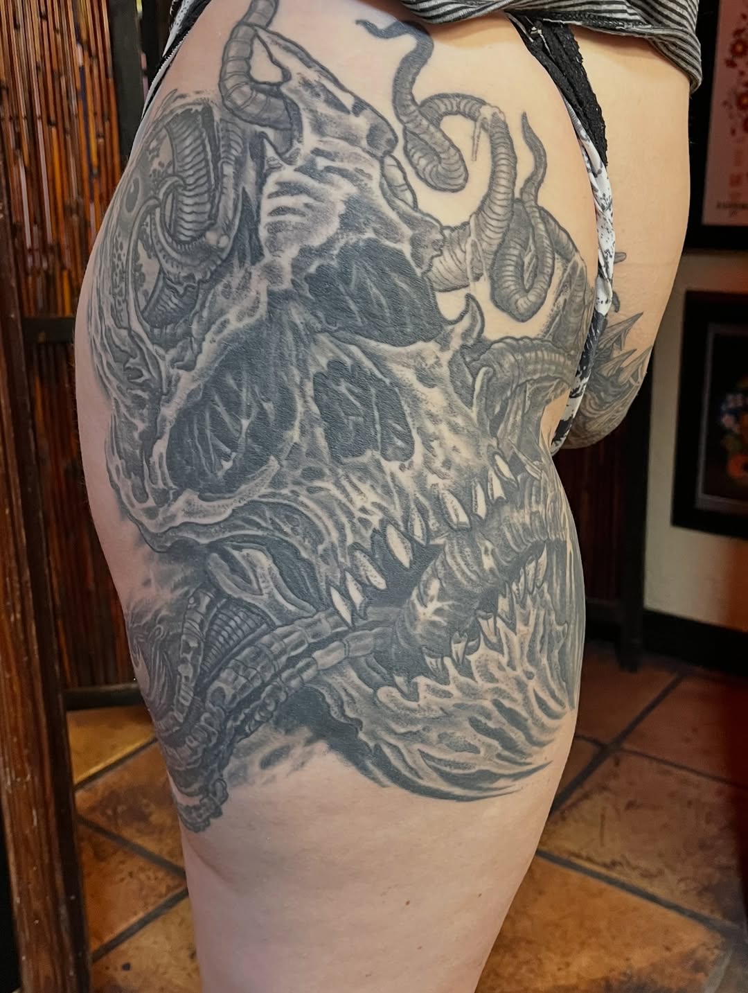 Monstrous grayscale skull entwined with writhing tentacles.