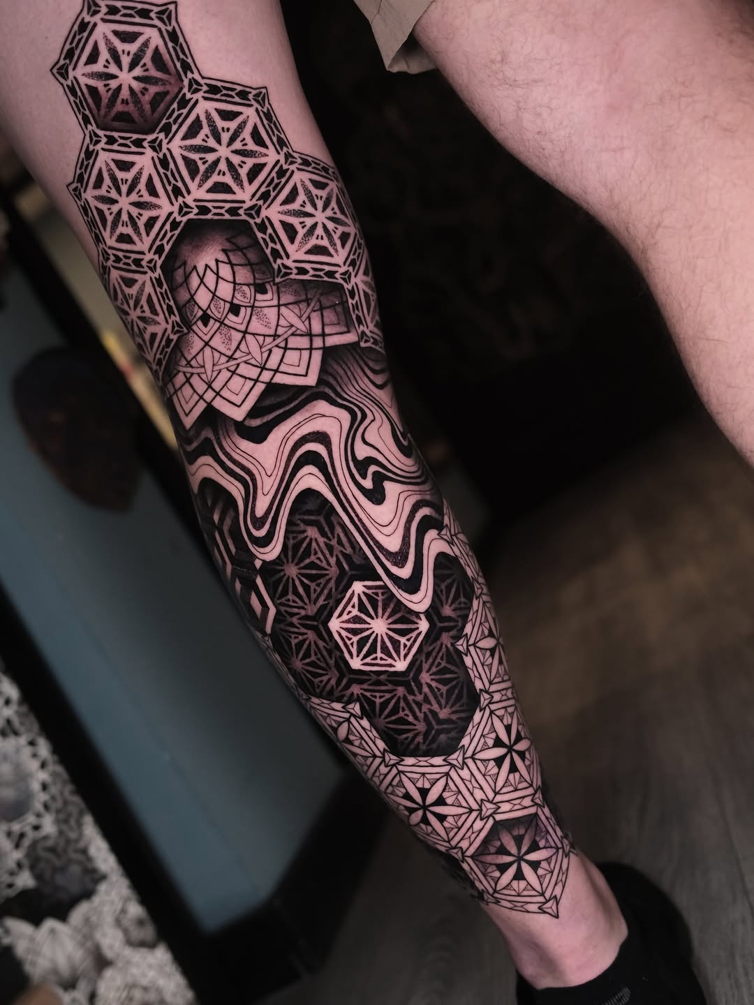 Intricate geometric leg sleeve with tessellated hex patterns and mosaic shading