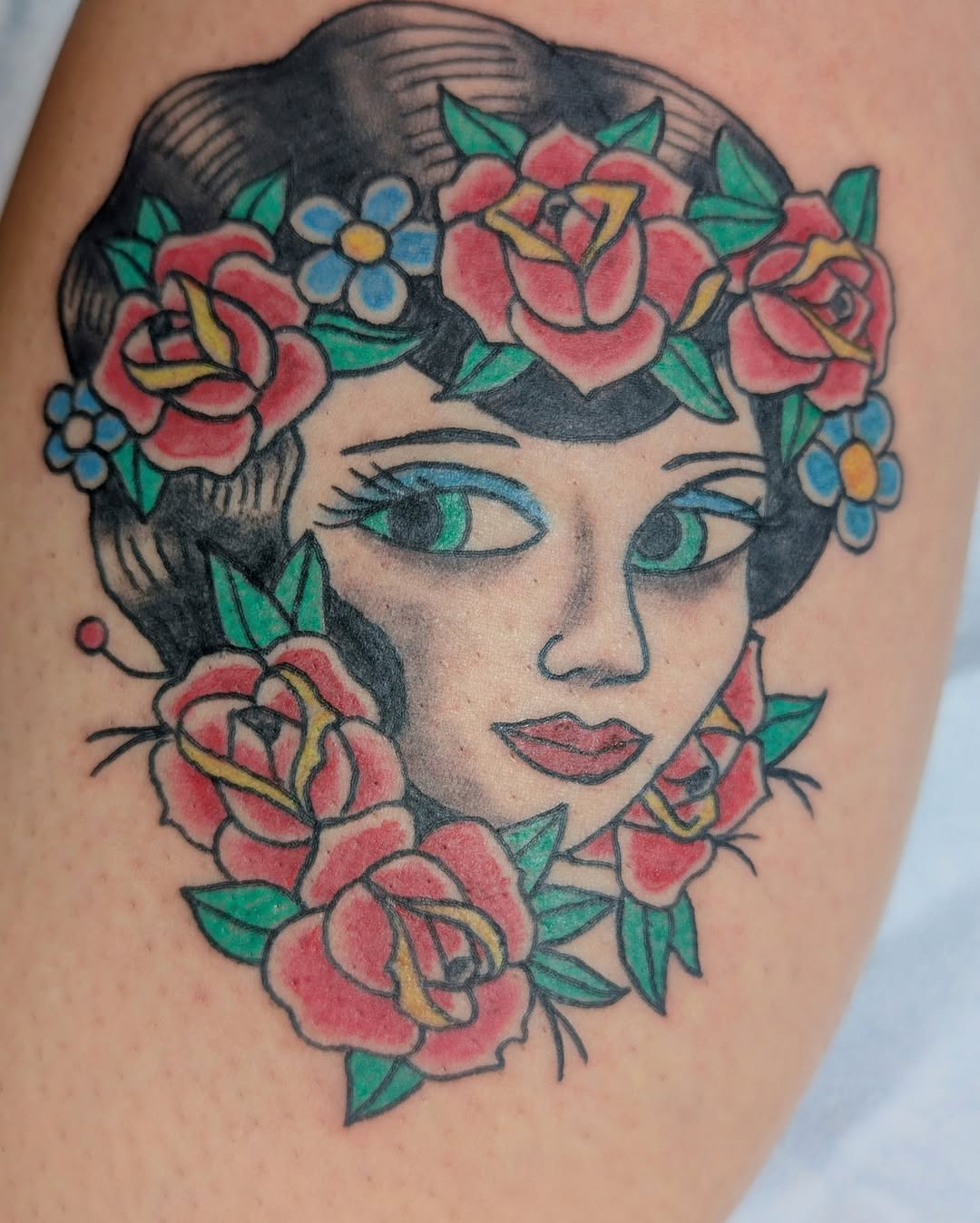 Bold neo-traditional female portrait framed by vibrant florals.