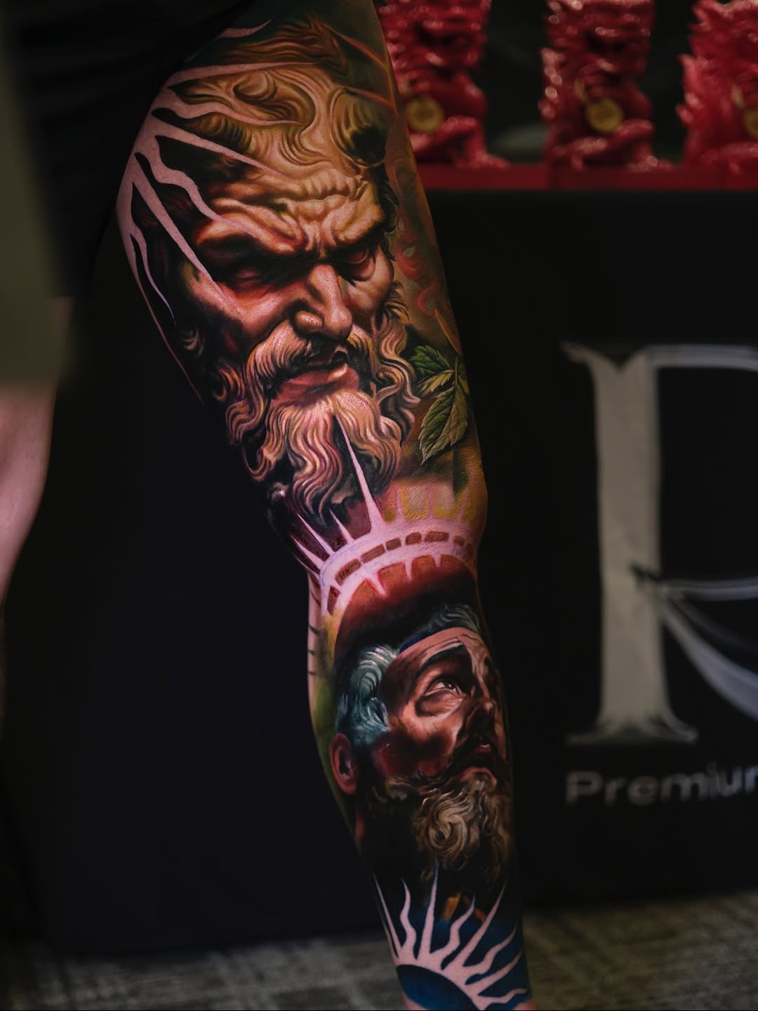 Vibrant full-sleeve of mythic faces in bold color