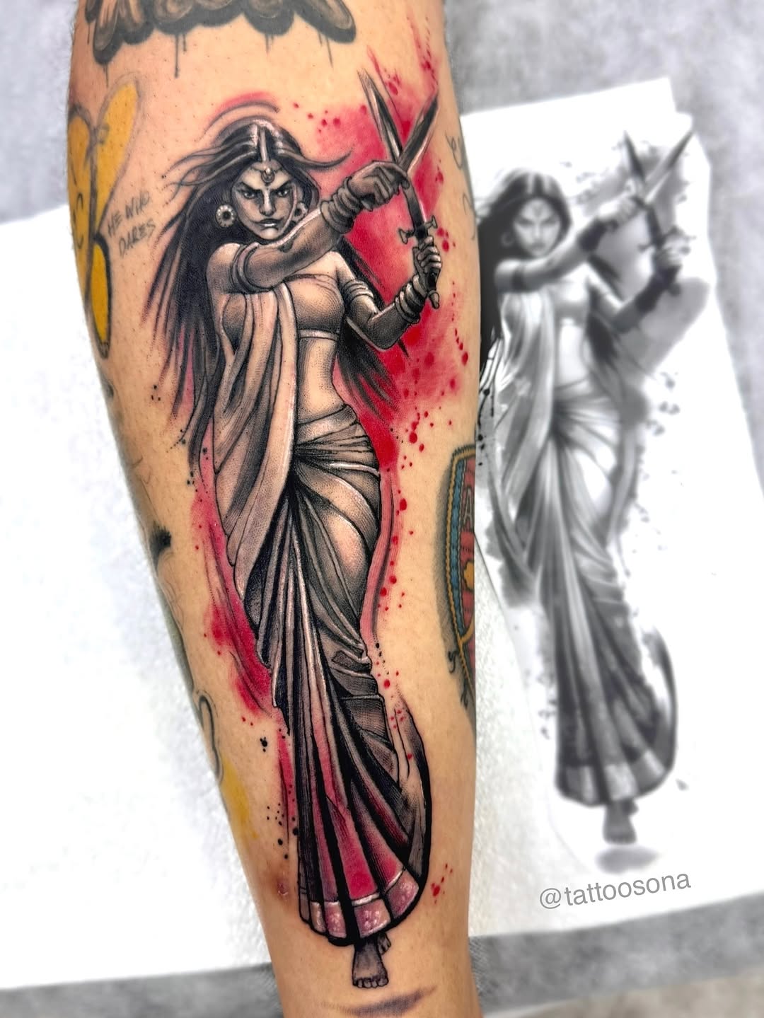 Warrior queen in flowing sari, bold black-gray with red splashes.