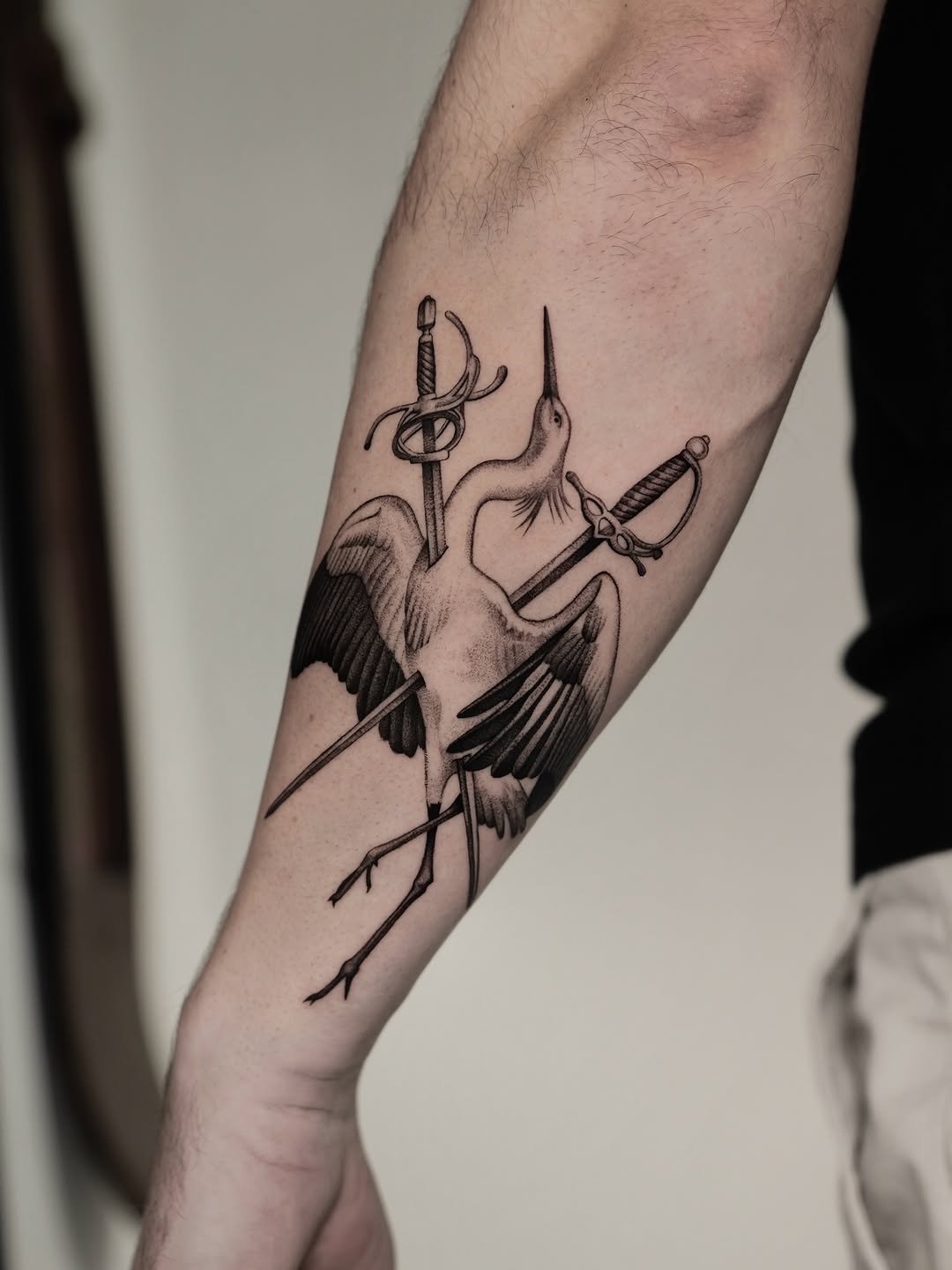 Bold blackwork heron with crossed swords motif