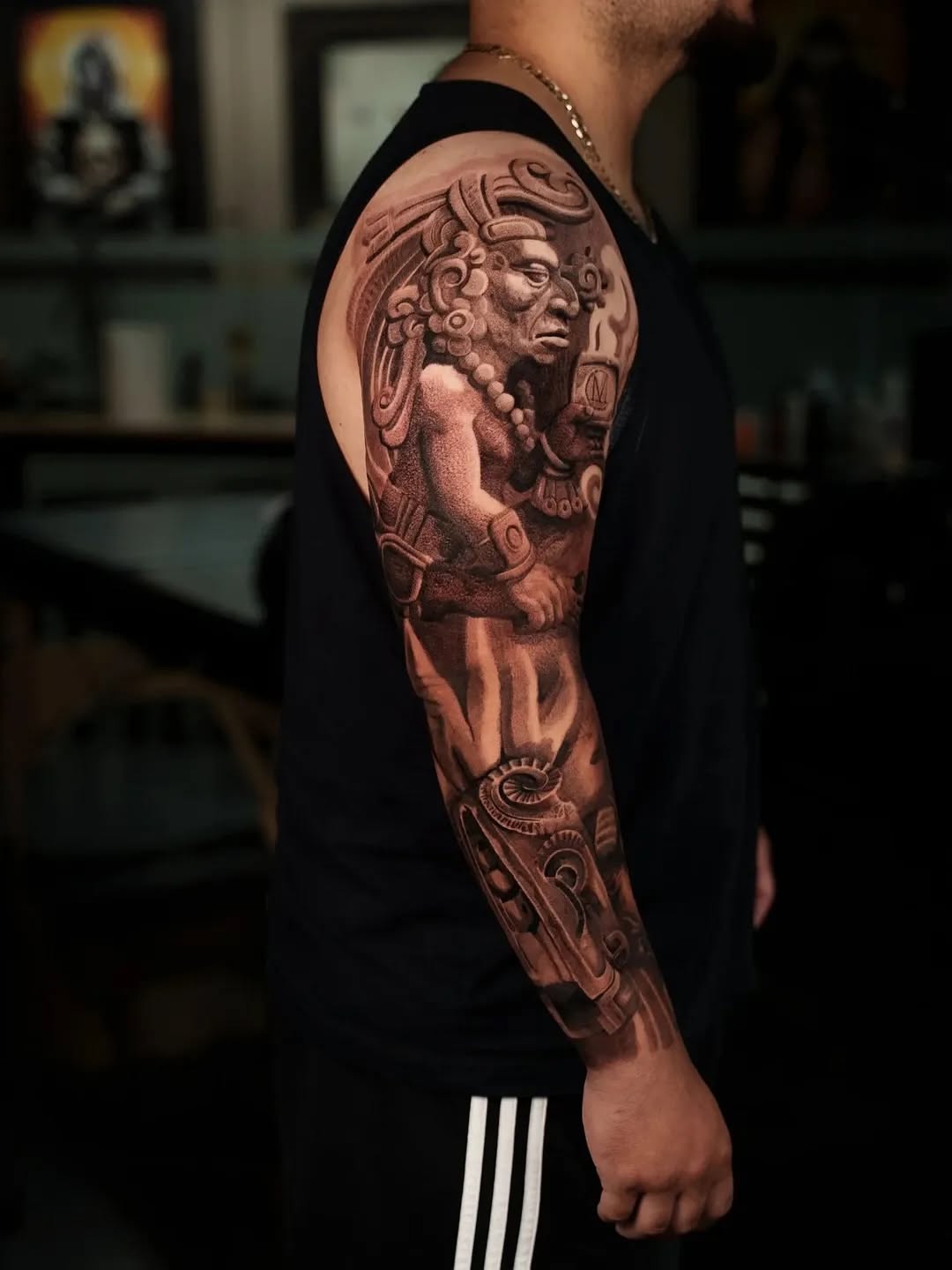 Monumental black-and-gray deity sleeve with ornate headdress