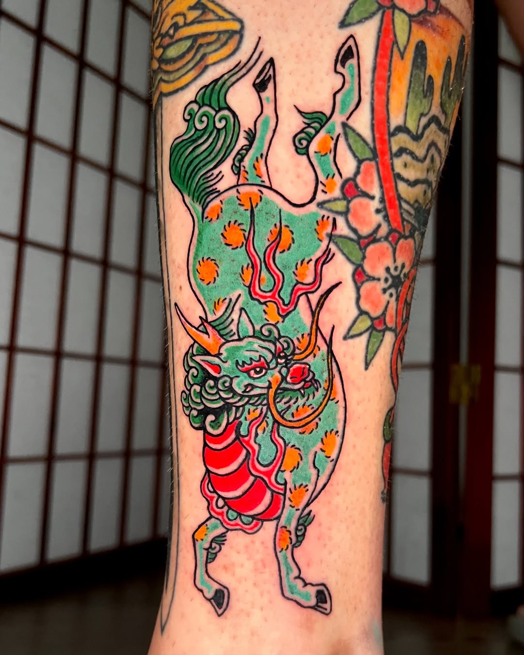 Bold traditional qilin with emerald body and orange accents