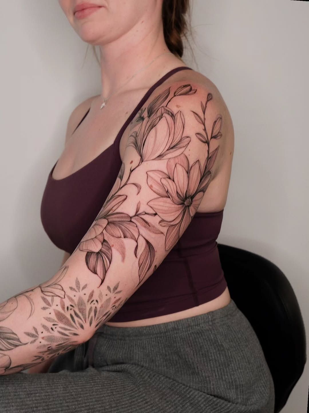Floral magnolia tattoo on arm