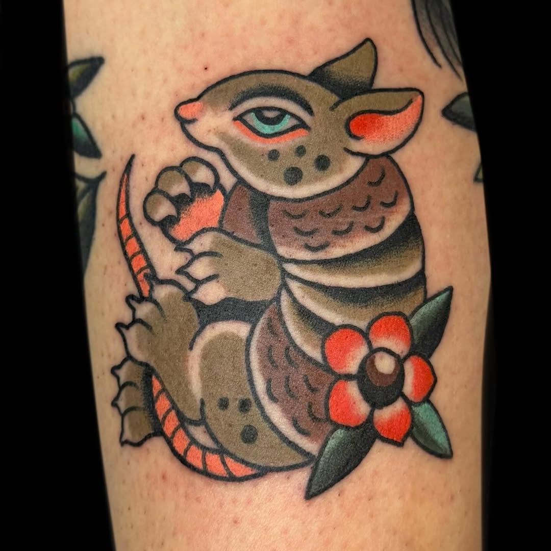 Bold armadillo-inspired critter in traditional style with flower