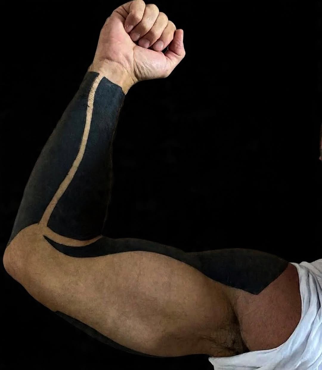 Bold black geometric tribal forearm sleeve with clean lines.