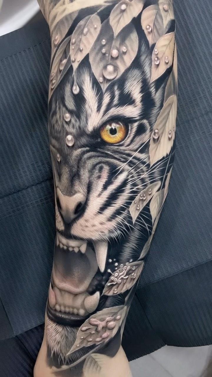 Hyper-detailed grayscale tiger head surrounded by dew-dotted leaves