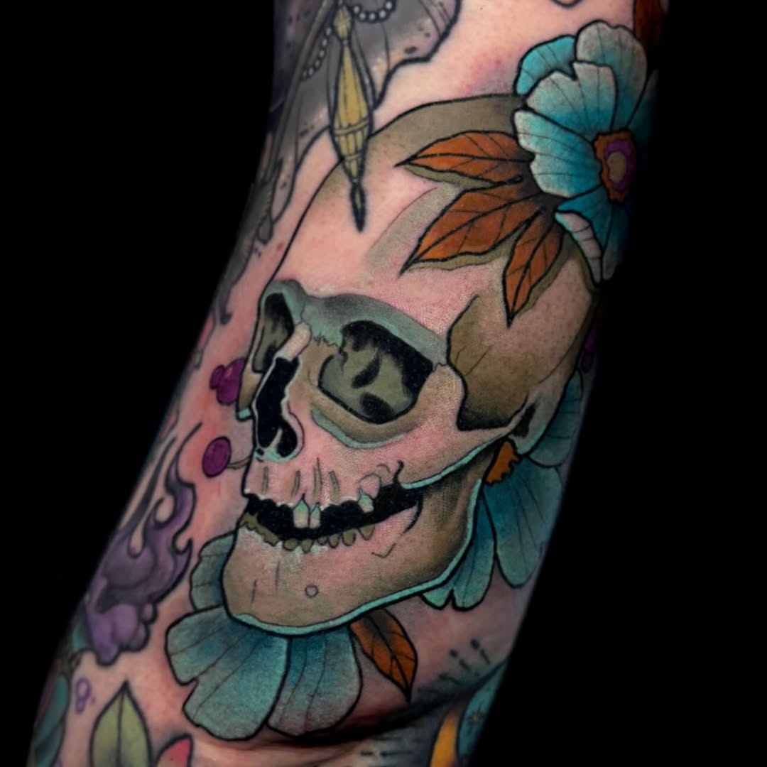 Vivid skull centerpiece surrounded by turquoise petals