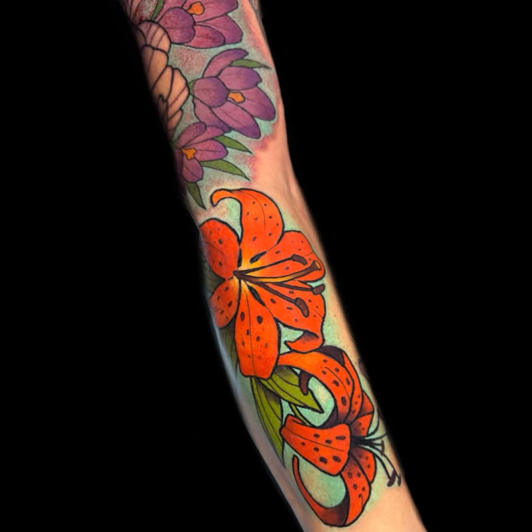 Vivid orange lilies with purple blossoms in bold neo-traditional